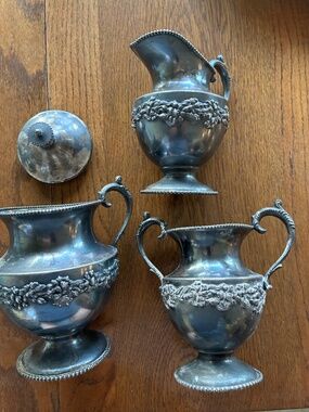 Vintage silver plate creamer, sugar bowl and vase.